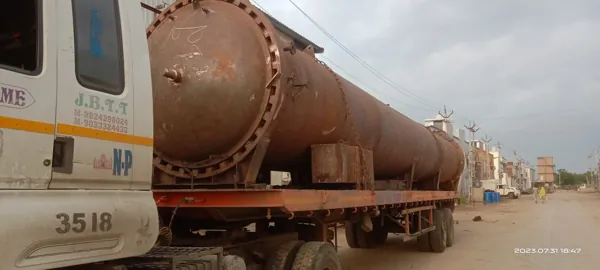 Long cylindrical vessel being transported